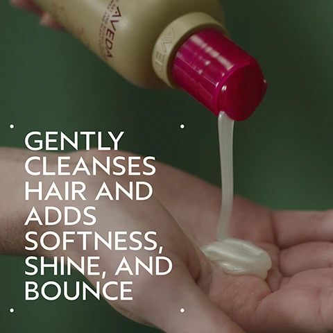 Image 2 - A hand pours creamy white product from an Aveda bottle with a pink cap into another hand, with text overlay that reads GENTLY CLEANSES HAIR AND ADDS SOFTNESS, SHINE, AND BOUNCE. Image 3 - The image displays a before and after comparison of a woman with long red hair; on the left, her hair is wavy and appears unwashed, with the visible text BEFORE Unwashed Hair, and on the right, her hair is straight, smooth, and shiny, with the visible text AFTER Results with Cherry Almond Softening Shampoo and Conditioner, Speed of Light Blow Dry Accelerator, Thickening Tonic, Botanical Repair™ Bond-Building Styling Crème, and Air Control Light Hold Hair Spray. Blow dried with Wooden Paddle Brush. Image 4 - The image shows a dark green background with a beige circular area featuring three ripe oranges on branches with green leaves and white blossoms, next to several dark brown tonka beans, with the text Uplift Your Mood and A sweet floral aroma with tonka bean, orange, and ylang-ylang. Image 5 - The image shows a four-step hair care guide with corresponding circular photos: wet hair being shampooed, conditioner dispensed into a hand, a hand spraying a product, and a collection of styling products and a brush on a tray; the visible text reads HOW TO USE 01 CLEANSE Cherry Almond Softening Shampoo 02 CONDITION Cherry Almond Conditioner 03 PREP Speed of Light Blow Dry Accelerator 04 STYLE Thickening Tonic, Botanical RepairTM Bond-Building Styling Crème, Air Control Light Hold Hair Spray & Wooden Paddle Brush. Image 6 - A before and after image shows a woman with blonde hair; on the left, labeled BEFORE, her hair is straight and appears unwashed, with the additional text Unwashed Hair, while on the right, labeled AFTER, her hair is styled in voluminous waves and looks shiny, with the additional text Results with Cherry Almond Softening Shampoo, Conditioner, and Leave-In Conditioner, Invati Ultra Advanced™ Thickening Foam, Texture Tonic and Woodle Paddle Brush. Blow dried with diffuser attachment and styled with curling iron. Image 7 - Three creamy, off-white dollops of product of varying sizes are on a white background, one large and two smaller. Image 8 - A close-up of dark green tropical leaves with a red plant stem features three white logos: a circular 100% VEGAN logo with a V, a Certified B Corporation logo, and a leaping rabbit Cruelty Free INTERNATIONAL logo.