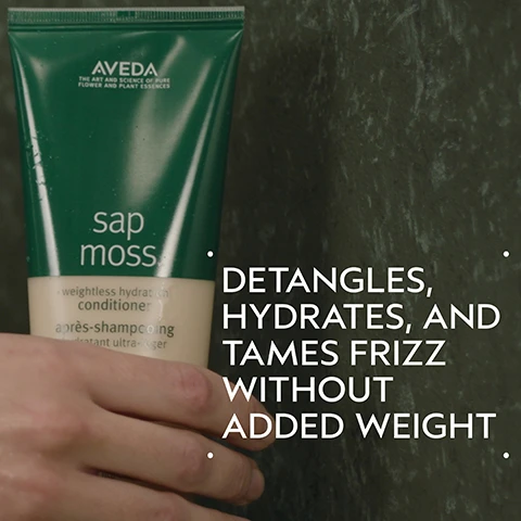 Image 2 - A hand holds a green and beige tube of conditioner against a dark mottled background, with text on the tube reading AVEDA THE ART AND SCIENCE OF PURE FLOWER AND PLANT ESSENCES sap moss weightless hydration conditioner après-shampooing hydratant ultra-léger and text on the right side of the image reading DETANGLES HYDRATES AND TAMES FRIZZ WITHOUT ADDED WEIGHT. Image 3 - A split image shows a woman before and after hair treatment; on the left, her hair is shoulder-length, reddish-brown, and appears unwashed, while on the right, it is wet-looking, darker, and styled smooth, with text BEFORE, AFTER, Unwashed Hair, and Results with Sap Moss™ Weightless Hydration Shampoo and Conditioner, Flax Seed Aloe Sculpting Gel, Firmata Firm Hold Hair Spray, and Mini Wooden Paddle Brush. Image 4 - A dark green graphic features a large central circular abstract design with swirling teal, green, and purple colors, and white text that reads Iceland Moss & Larch Tree Sap Extract Blend and Hydrates Hair Without Weighing It Down. Image 5 - A textured, yellowish-tan cream swatch with subtle peaks and a soft shadow is displayed on a white background. Image 6 - The image titled HOW TO USE provides a three-step hair routine: 01 CLEANSE shows hands washing hair with foam using Sap Moss™ Weightless Hydration Shampoo; 02 CONDITION depicts a hand receiving Sap Moss™ Weightless Hydration Conditioner from a bottle; and 03 STYLE features a collection of products including Flax Seed Aloe Sculpting Gel, Mini Wooden Paddle Brush. & Firmata Firm Hold Hair Spray. Image 7 - Three white certification logos are displayed against a dark green foliage background, reading 100% Vegan with a V, Certified B Corporation with a B in a circle, and Cruelty Free International with a leaping bunny graphic.