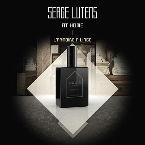 Image 2 - A black perfume bottle is centered in a diamond-shaped frame, with a blurred background showing shelves filled with towels; visible text reads SERGE LUTENS AT HOME LARMOIRE À LINGE.
Image 3 - A black and white image featuring a decorative lantern and a bottle of fragrance side by side, with shelves of neatly folded towels in the background, and the text SERGE LUTENS AT HOME | LARMOIRE À LINGE displayed prominently above.