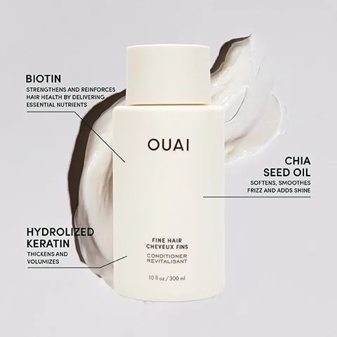 A white bottle of OUAI Fine Hair Conditioner sits against a light background, with visible text highlighting key ingredients: Biotin strengthens and reinforces hair health by delivering essential nutrients, Chia Seed Oil softens, smooths frizz and adds shine, and Hydrolyzed Keratin thickens and volumizes, with the bottle labeled 10 fl oz / 300 ml.