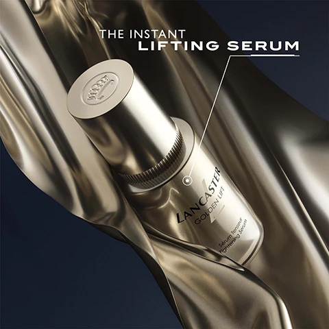 Image 1 - A golden serum bottle is placed against a smooth metallic background, with the text THE INSTANT LIFTING SERUM and LANCASTER GOLDEN JET displayed above and beside it.
Image 2 - A woman with flawless skin is applying a serum to her cheek, holding a bottle of Lancaster Golden Lift serum next to her face, with the text 100% SAY SKIN IS TIGHTENED IN JUST 2 WEEKS and a note about consumer testing in the bottom right corner.
Image 3 - A collection of cream jars with gold lids on a dark background, featuring text that reads ANTI-DARK CIRCLES ANTI-PUFFINESS.
Image 4 - A close-up portrait of a young woman with smooth skin and dark hair is shown, highlighting her eyes, with text indicating 99% of participants saw lifted eyebrows in just 2 weeks and 97% saw lifted eye contour in the same time, along with the statement that the entire eye contour area is lifted.
Image 5 - Image of a jar of Lancaster Golden Lift sculpting cream against a backdrop of draped metallic fabric, with text highlighting benefits: Lift & Sculpt, Reduce Dark Spots, Tighten Face Contours.
Image 6 - A close-up of a womans face showcasing healthy skin, with the text stating +20% skin density, +19% redefined jawline, +18% skin elasticity, and the phrase skin is lifted & tightened at the bottom.
Image 7 - Image depicts three skincare products from the Lancaster Golden Lift line, including a tightening serum, eye-lifting cream, and sculpting cream, with visible text listing their uses and application instructions.