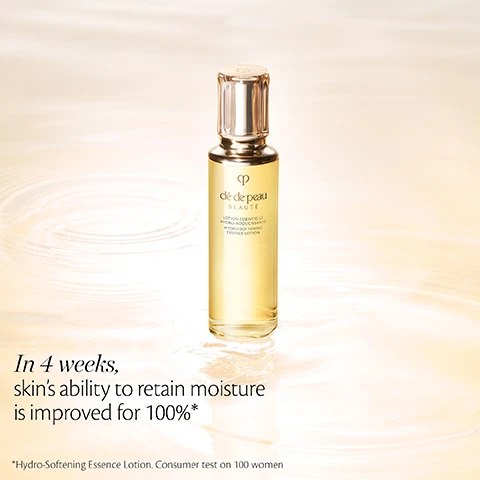 Image 2 - An elegant bottle of Clé de Peau Beauté Hydro-Softening Essence Lotion, filled with golden liquid and topped with a clear and gold cap, stands on a rippled, light background, with the bottle label reading Clé de Peau Beauté LOTION ESSENTIELLE HYDRO-ADOUCISSANTE HYDRO-SOFTENING ESSENCE LOTION, and additional text stating In 4 weeks, skins ability to retain moisture is improved for 100%* and below that *Hydro-Softening Essence Lotion. Consumer test on 100 women. Image 3 - A graphic on a light blue background features three circular insets: one shows a creamy substance for fortified amino ferment, another white lily flowers for radiant lily extract, and the third yellow witch hazel flowers, with accompanying text reading, FORTIFIED AMINO FERMENT TO BOOST THE MOISTURIZING EFFECT, RADIANT LILY EXTRACT TO ACT ON SKIN DEFENSE, and NORMAL TO DRY SKIN: WITCH HAZEL EXTRACT REFINE SKIN TEXTURE. Image 4 - Two Clé de Peau Beauté essence lotion bottles, one golden yellow with a label reading LOTION ESSENTIELLE HYDRO-ADOUCISSANTE HYDRO-SOFTENING ESSENCE LOTION, and one light blue with a label reading LOTION ESSENTIELLE HYDRO-CLARIFIANTE HYDRO-CLARIFYING ESSENCE LOTION, are displayed with gold caps on a reflective surface surrounded by white flowers and clear curved tubes containing droplets, under the main text HYDRATE, with the Lotions.